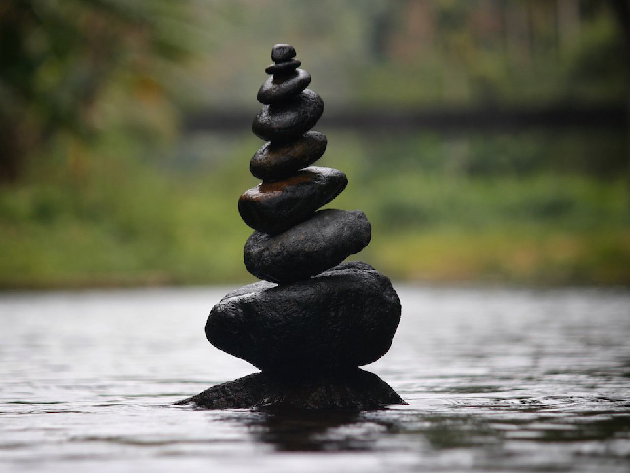 eight balanced stones in water